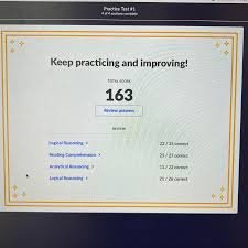Student preparing for LSAT exam with study guide and practice tests