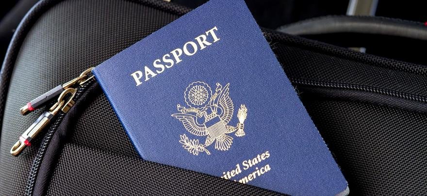 Passenger holding real USA passport at international airport